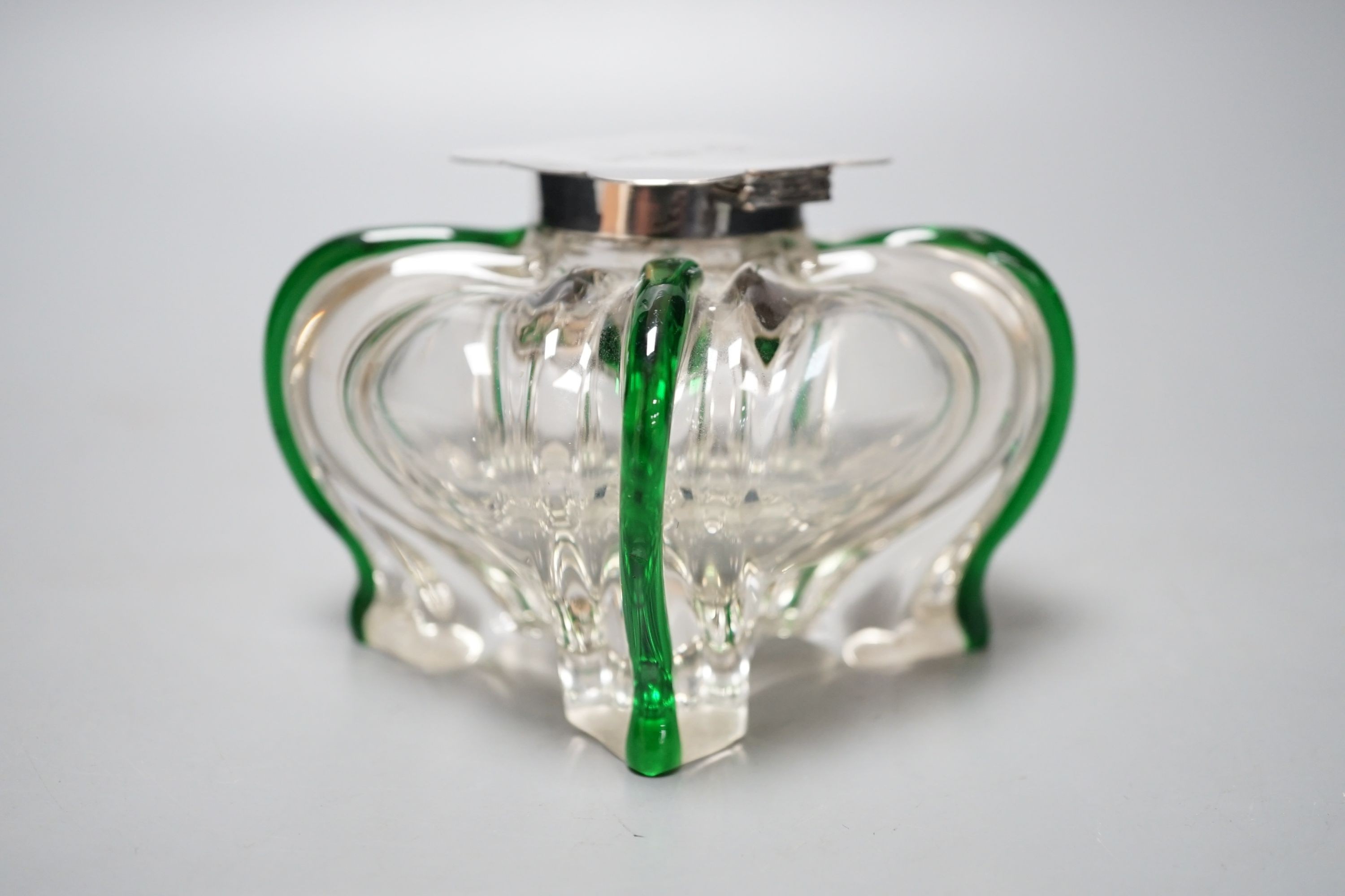 A silver-mounted green trailed glass inkwell, possibly Powell, Whitefriars. The lid initialled ‘G.B.H’ Height - 8cm